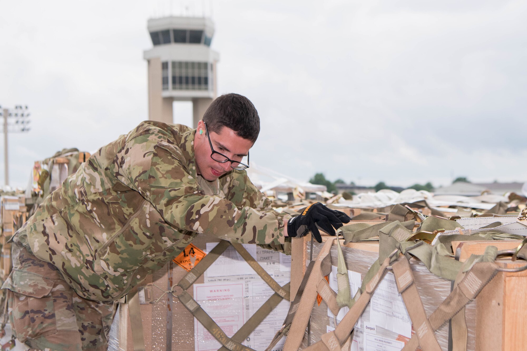 Senior Airman Thomas White, 436th Aerial Port Squadron ramp services journeyman, pushes pallets of ammunition bound for Tajikistan onto an aircraft at Dover Air Force Base, Delaware, June 22, 2021. Security cooperation between the U.S. and Tajikistan advances shared security interests and supports regional stability in Central Asia. (U.S. Air Force photo by Mauricio Campino)