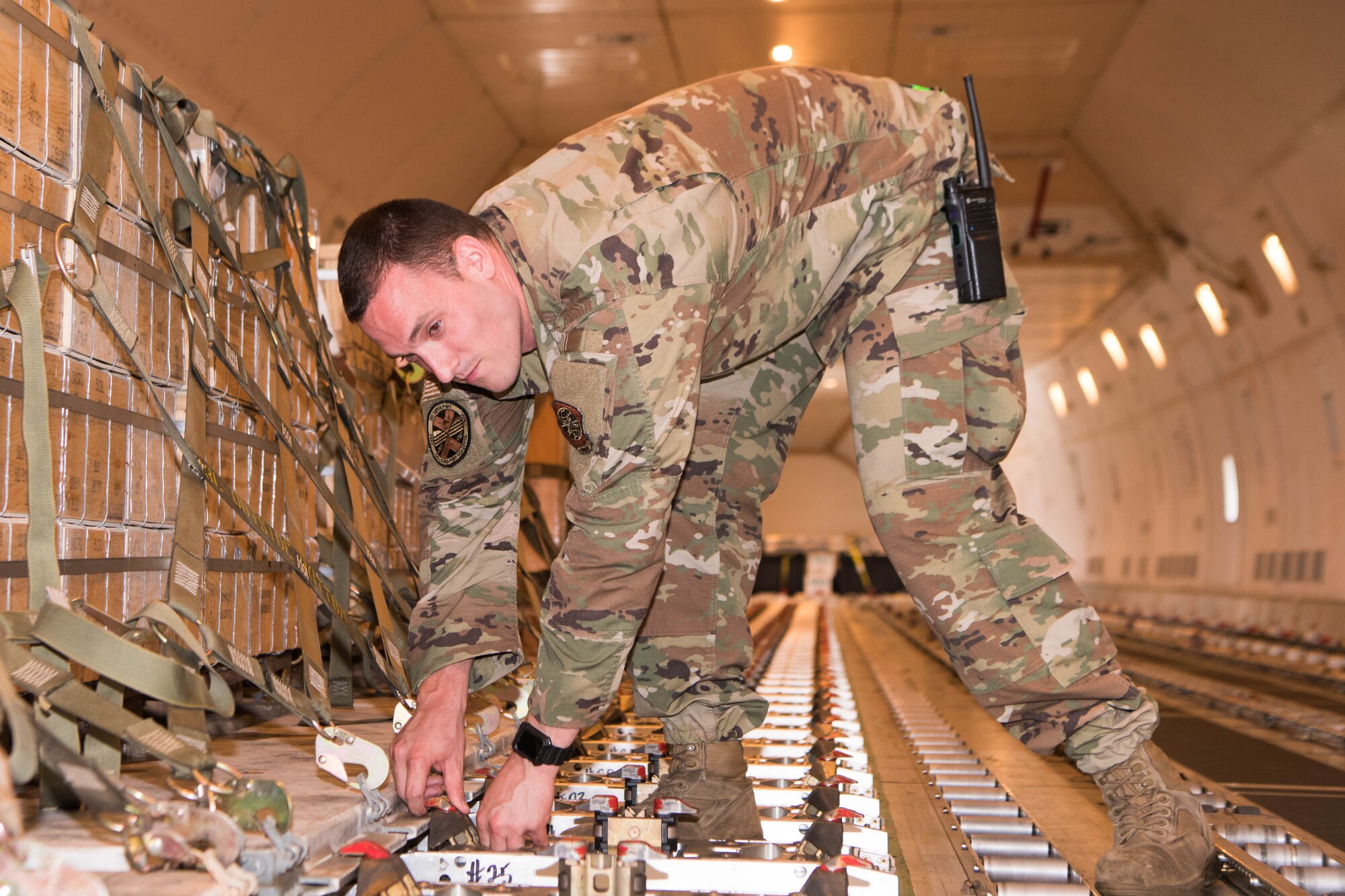 Staff Sgt. Cheyne Devens, 436th Aerial Port Squadron Air Traffic Operations Center senior controller, configures cargo floor rollers on an aircraft bound for Ukraine at Dover Air Force Base, Delaware, June 22, 2021. Missions like this demonstrate the U.S. commitment to Ukraine’s independence, sovereignty and territorial integrity. (U.S. Air Force photo by Mauricio Campino)