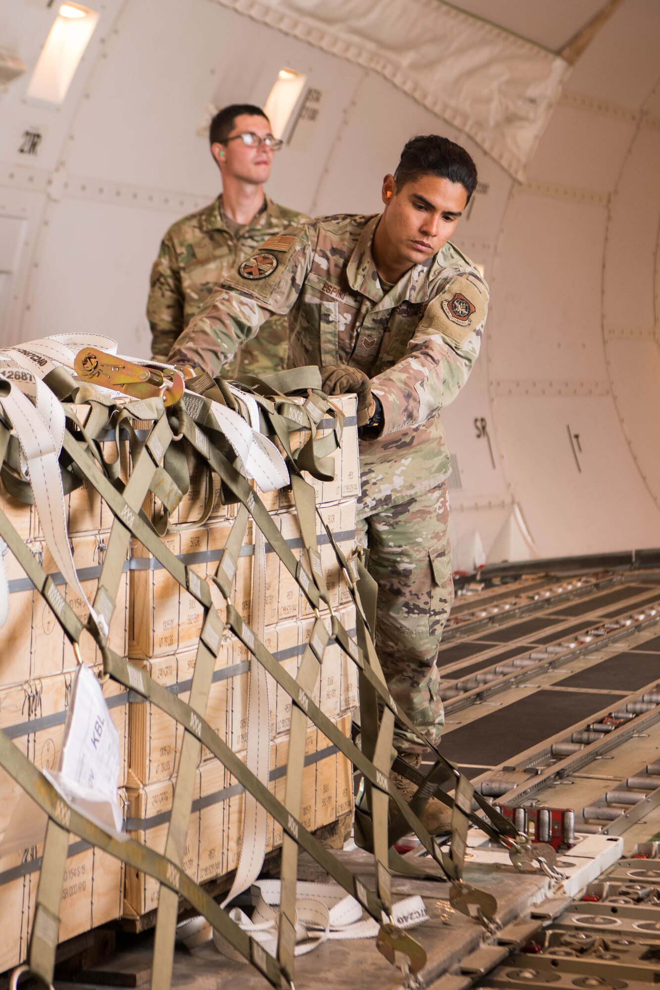 Staff Sgt. Manuel Espino, 436th Aerial Port Squadron ramp services supervisor, pushes a pallet of materiel into place on an aircraft bound for Ukraine, at Dover Air Force Base, Delaware, June 22, 2021. Missions like this demonstrate the U.S. commitment to Ukraine’s independence, sovereignty and territorial integrity. (U.S. Air Force photo by Mauricio Campino)