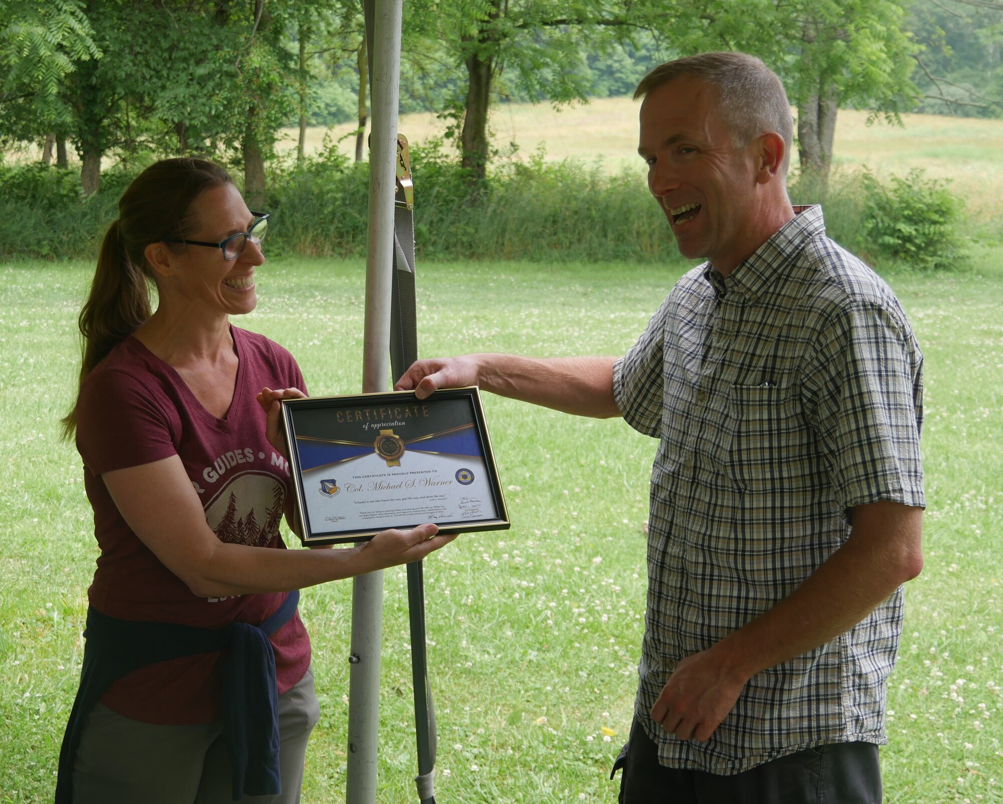 Col. Michael Warner, on right, accepts “Awesome Boss” award from team leader Charlie Sanner. (U.S. Air Force photo/Spencer Deer)