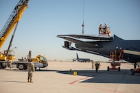 U.S. Airmen from the 151st Air Refueling Wing, Utah Air National Guard and 190th Air Refueling Wing, Kansas Air National Guard, remove the tail from a KC135R at Roland R. Wright Air National Guard Base, Utah, June 2, 2021.