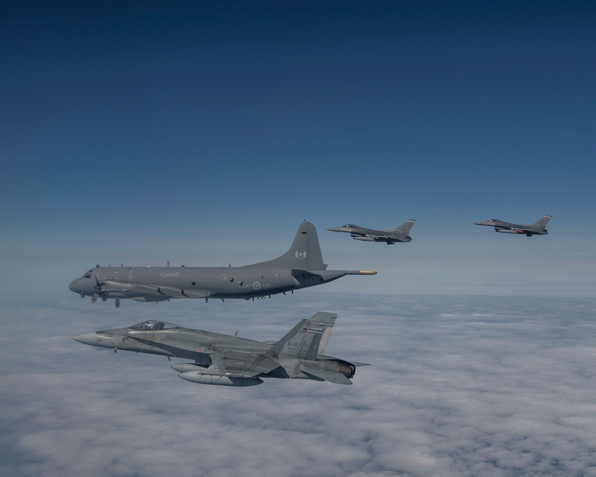 Royal Canadian Air Force CF-18 fighters from the 433 Tactical Fighter Squadron, 3 Wing, Bagotville, U.S. Air Force F-16 fighters from the 140th Wing, Colorado Air National Guard, and an Royal Canadian Air Force CP-140 Long Range Patrol aircraft from 14 Wing, Greenwood, Nova Scotia, conduct a mission over the Northeast corner of Newfoundland and Labrador during the Exercise Amalgam Dart on the Monday June 14, 2021.