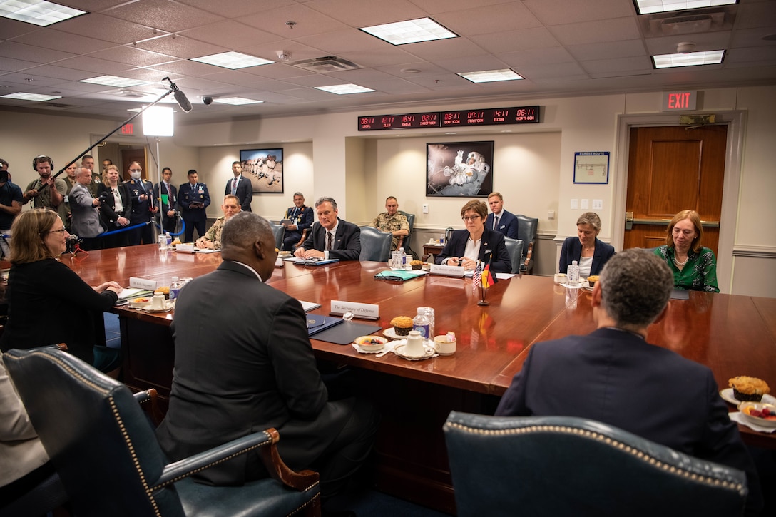 People sit around a large conference table.