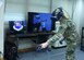 Woman in Air Force uniform wears virtual reality headset while training