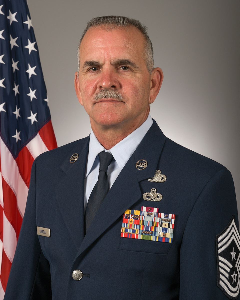 Command Chief Master Sgt. Brian Carroll poses for an official portrait June 29, 2021 in the 115th Fighter Wing public affairs studio at Truax Field, Madison, Wisconsin. (U.S. Air National Guard photo by Master Sgt. Paul Gorman)