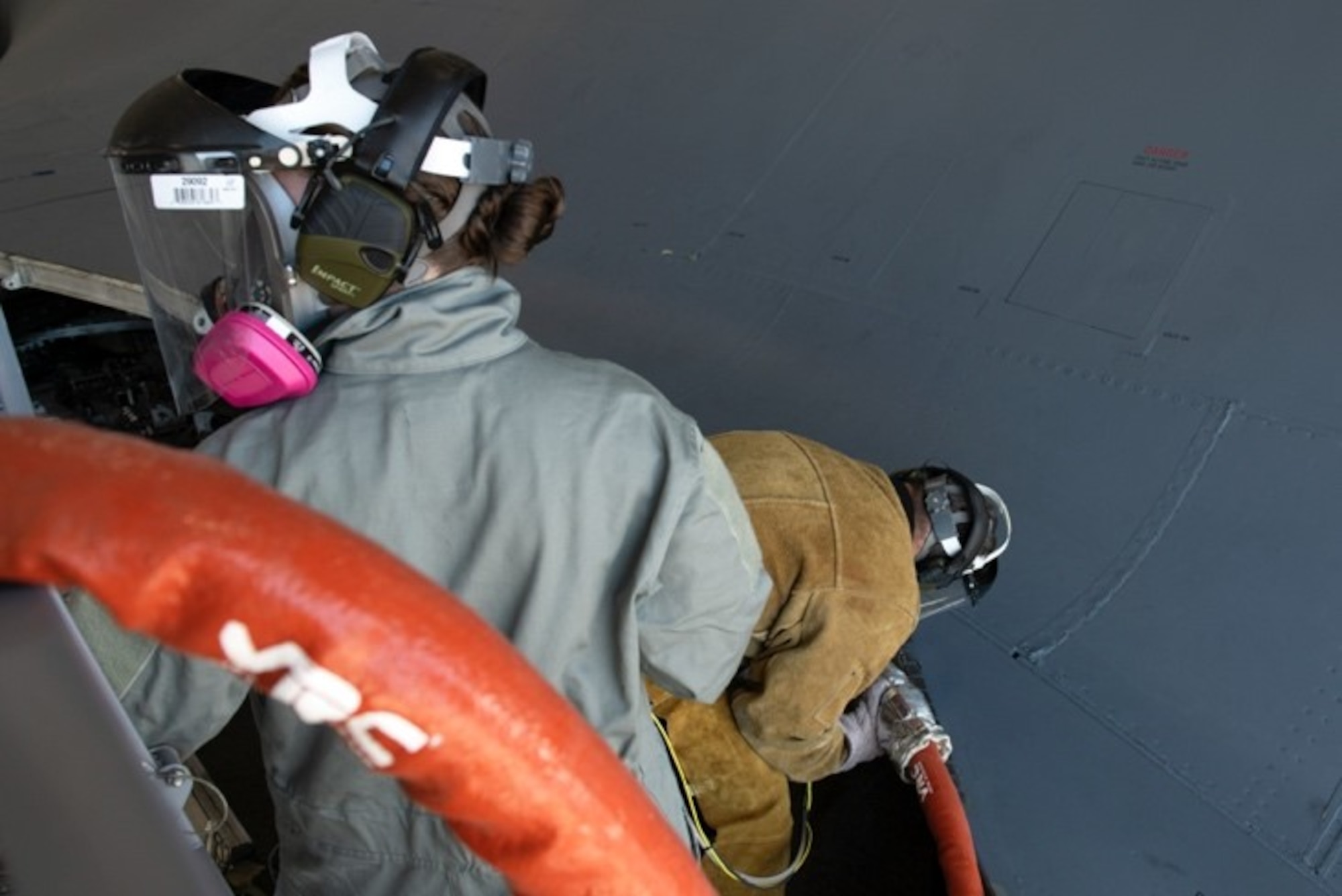 Staff Sgt. Chynna Patterson, a 28th Maintenance Group additive manufacturing spray technician, and David Darling, the 28th MXG additive manufacturing site manager, performs a cold spray restoration at Ellsworth Air Force Base, S.D., May 12, 2021.