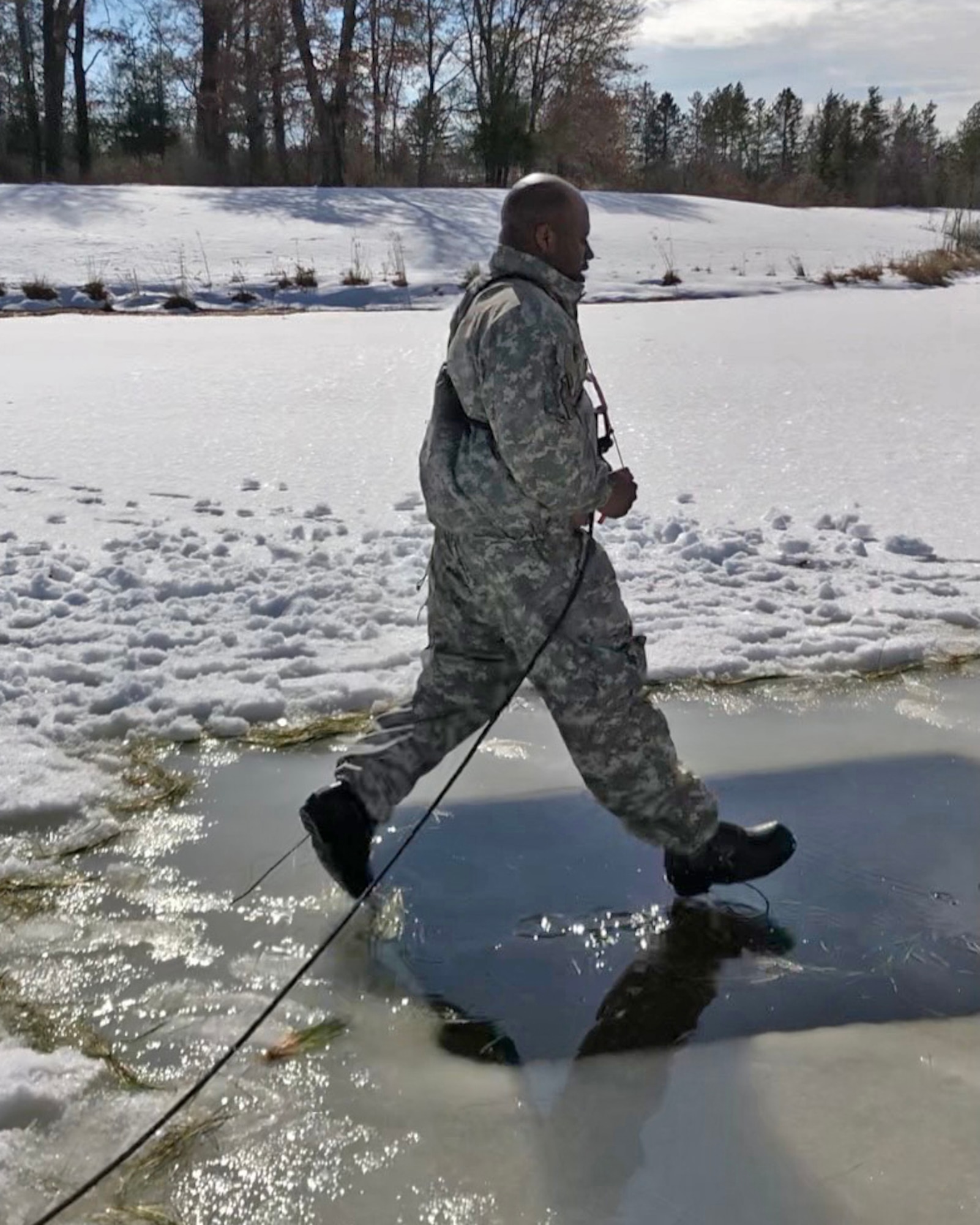 Staff Sgt. Rashad Wilson jumps into freezing water at U.S. Army's Cold Weather Operations Course.
