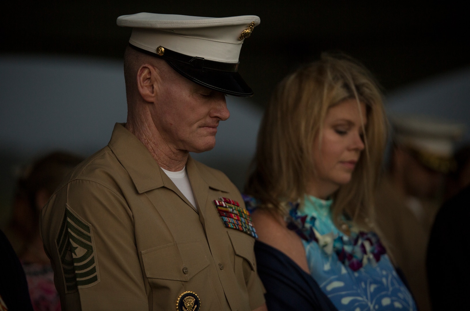 U.S. Marine Corps Sgt. Maj. Paul G. McKenna, outgoing sergeant major of U.S. Marine Corps Forces, Pacific, and his wife bow their heads during an invocation at a relief and appointment ceremony on Camp H.M. Smith, Hawaii, Feb. 9, 2018.