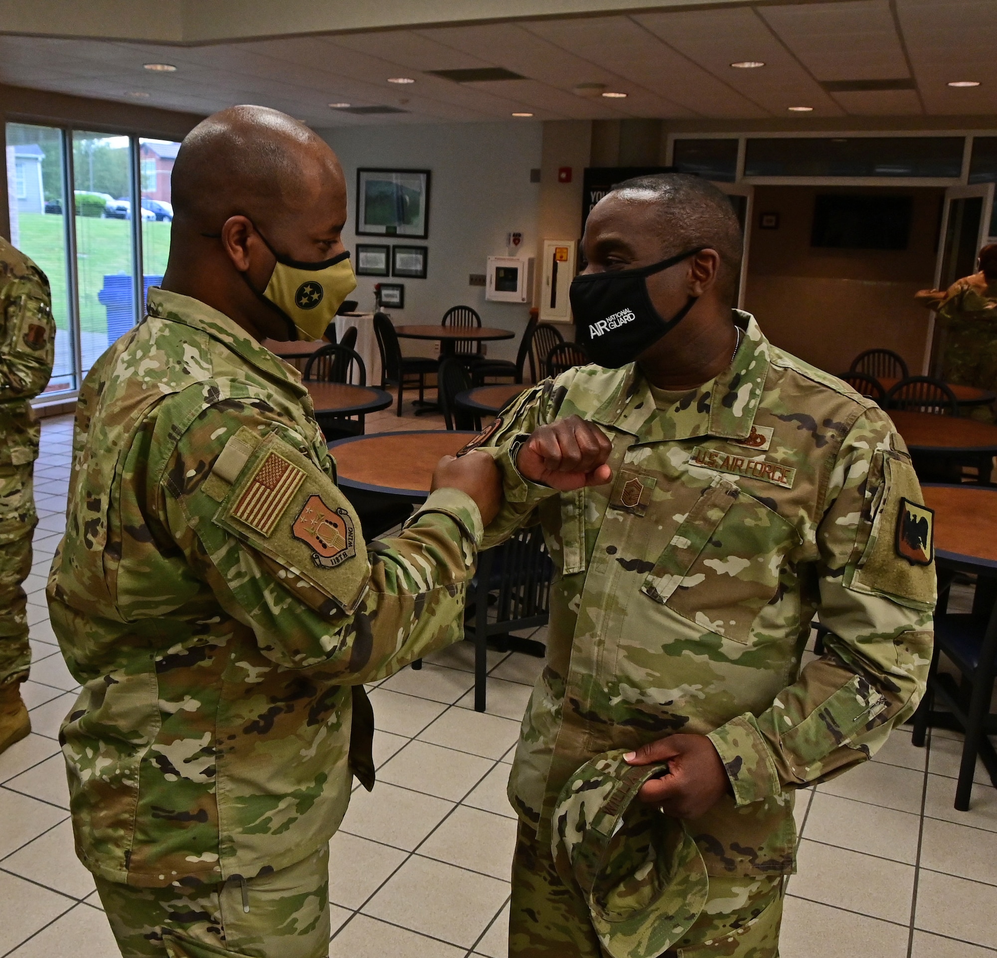 Chief Master Sgt. Maurice Williams fist bumps Staff Sgt. Rashad Wilson.