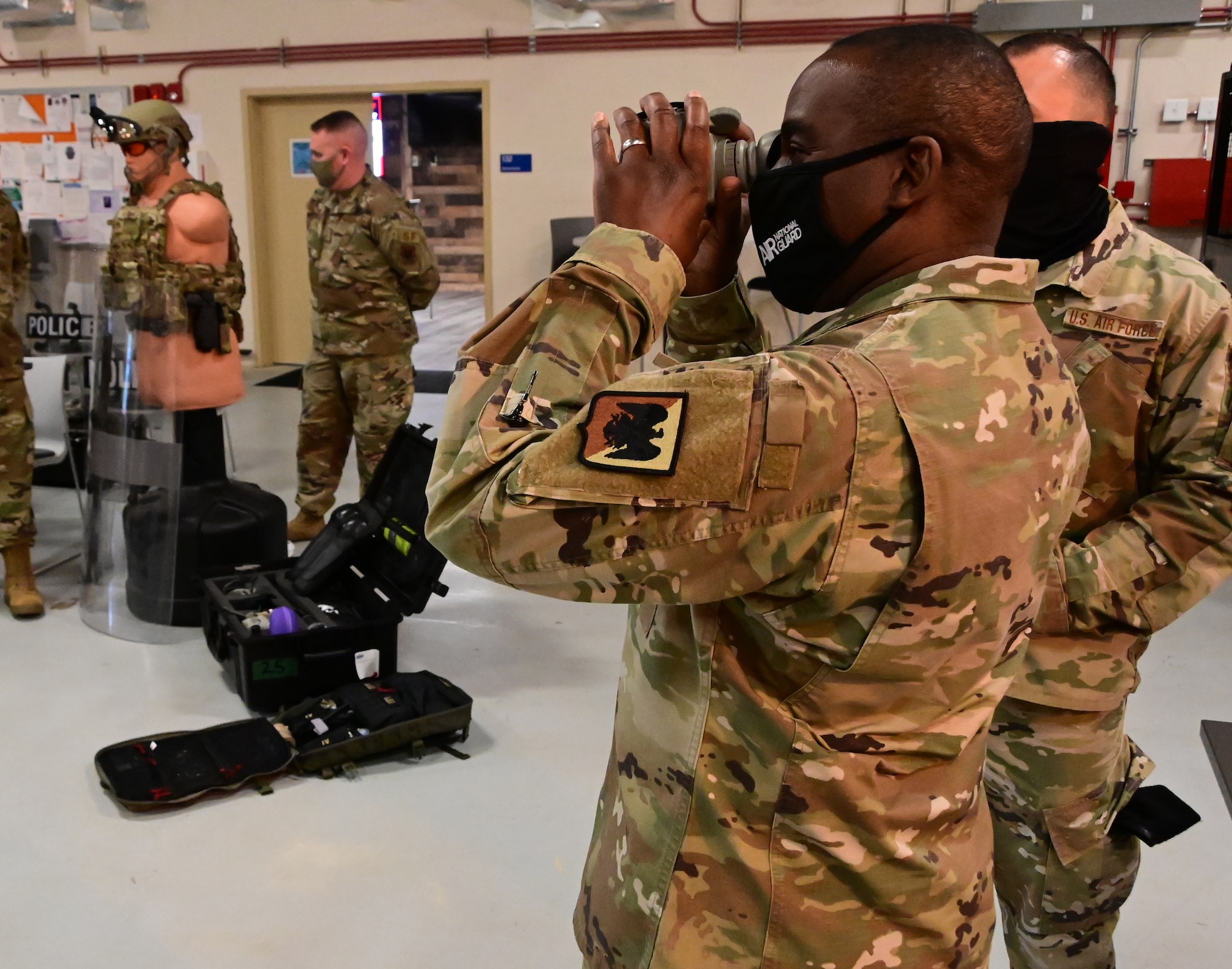 Chief Master Sgt. Maurice Williams looks through scope.