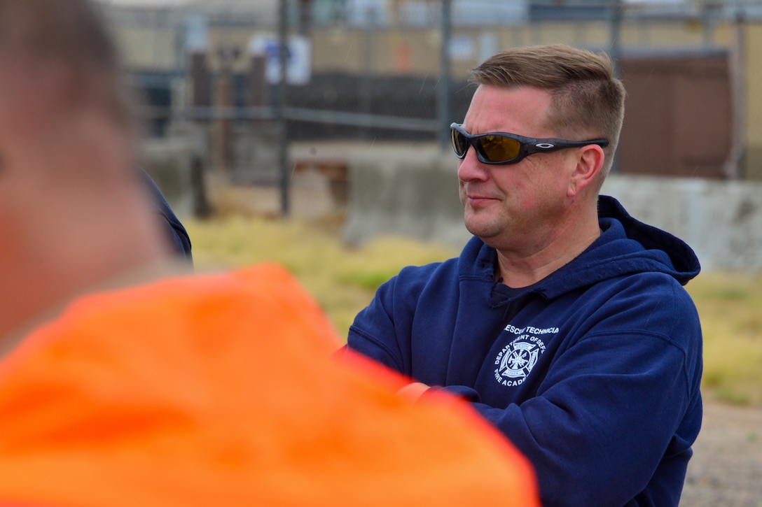 Man listens to a spill prevention protocol explanation at Kirtland, AFB.