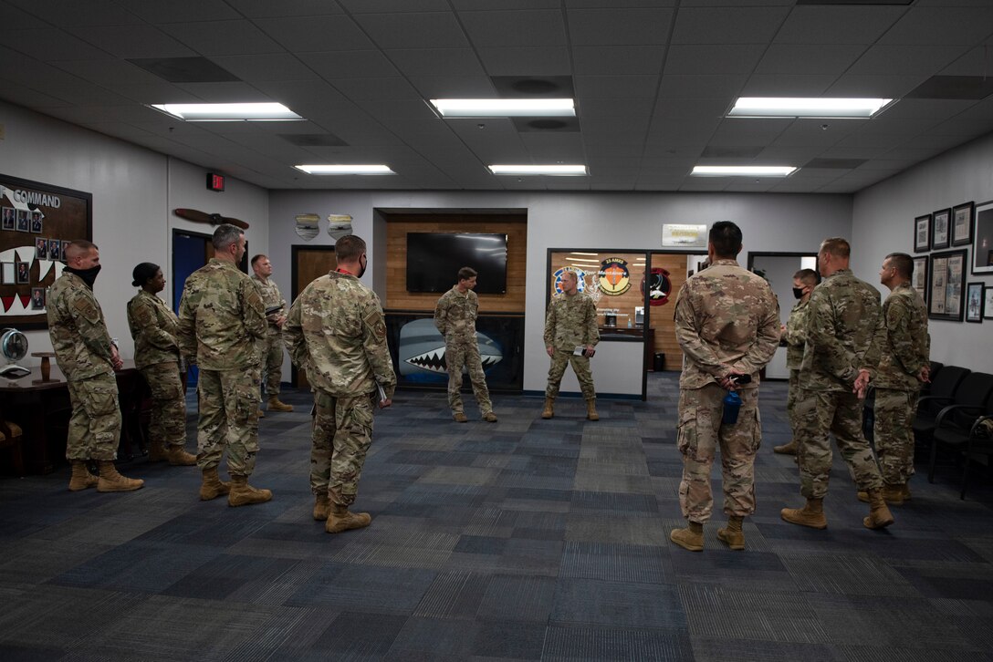 A photo of Airmen briefing base leadership.