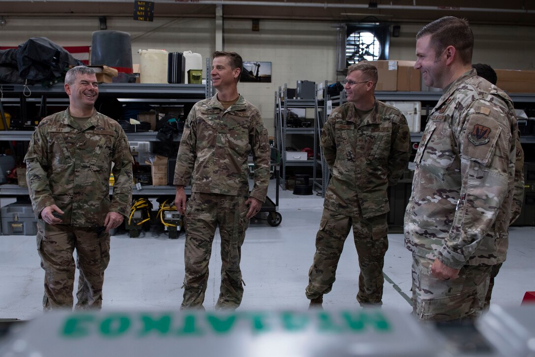 A photo of the base commander talking to leadership.