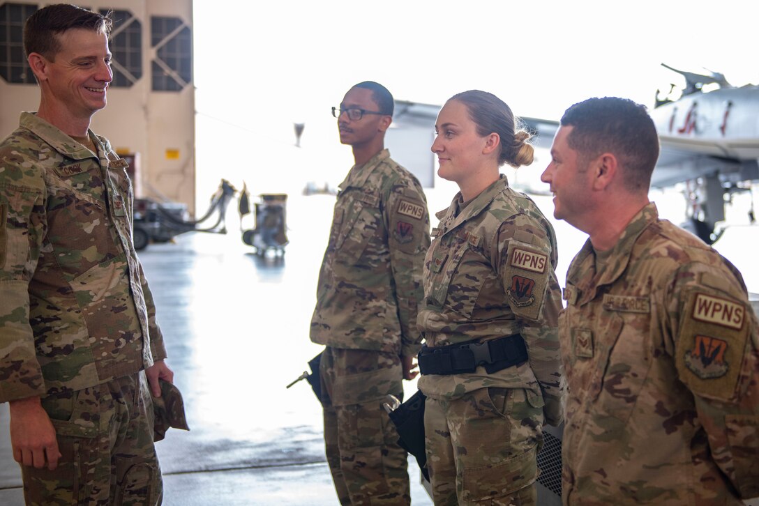 A photo of the base commander talking to Airmen.
