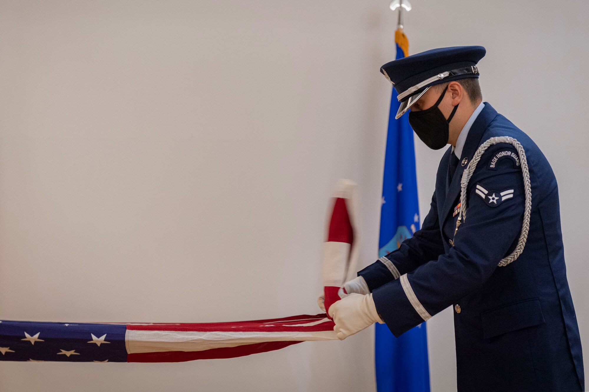 Photo of an Airman folding a flag