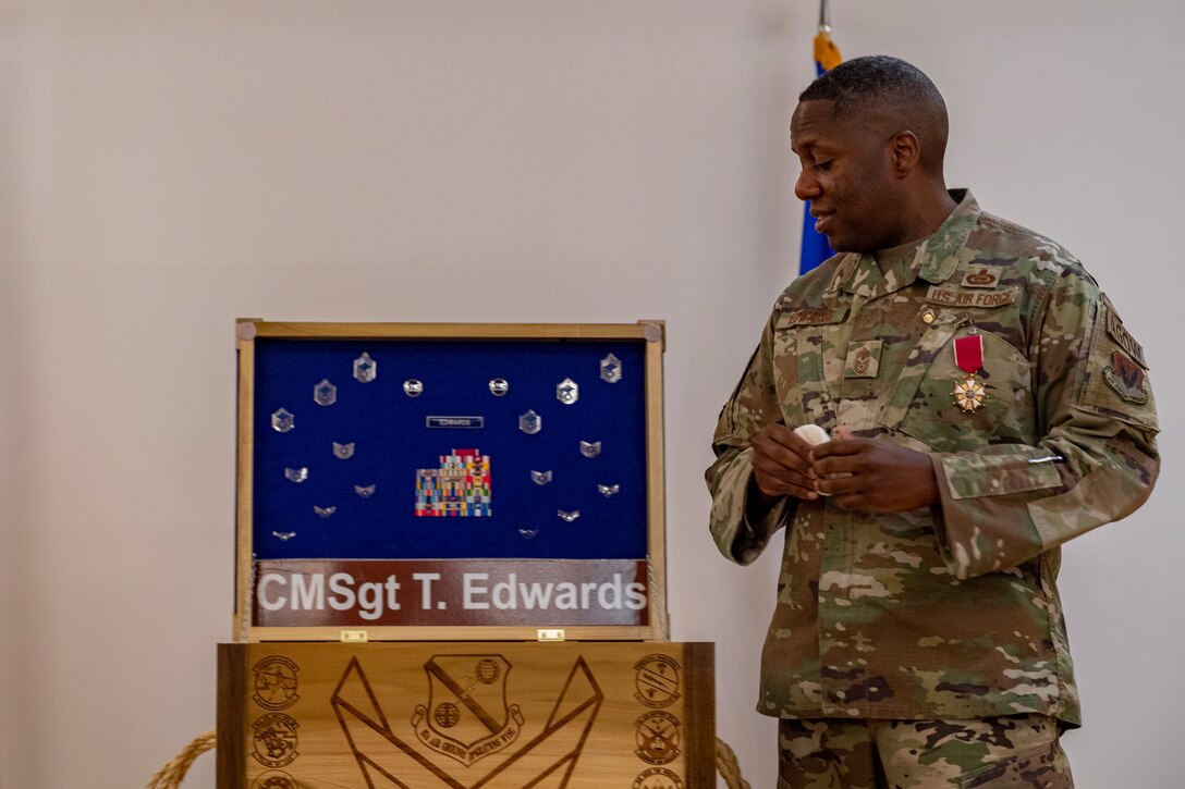 Photo of an Airman receiving a shadow box