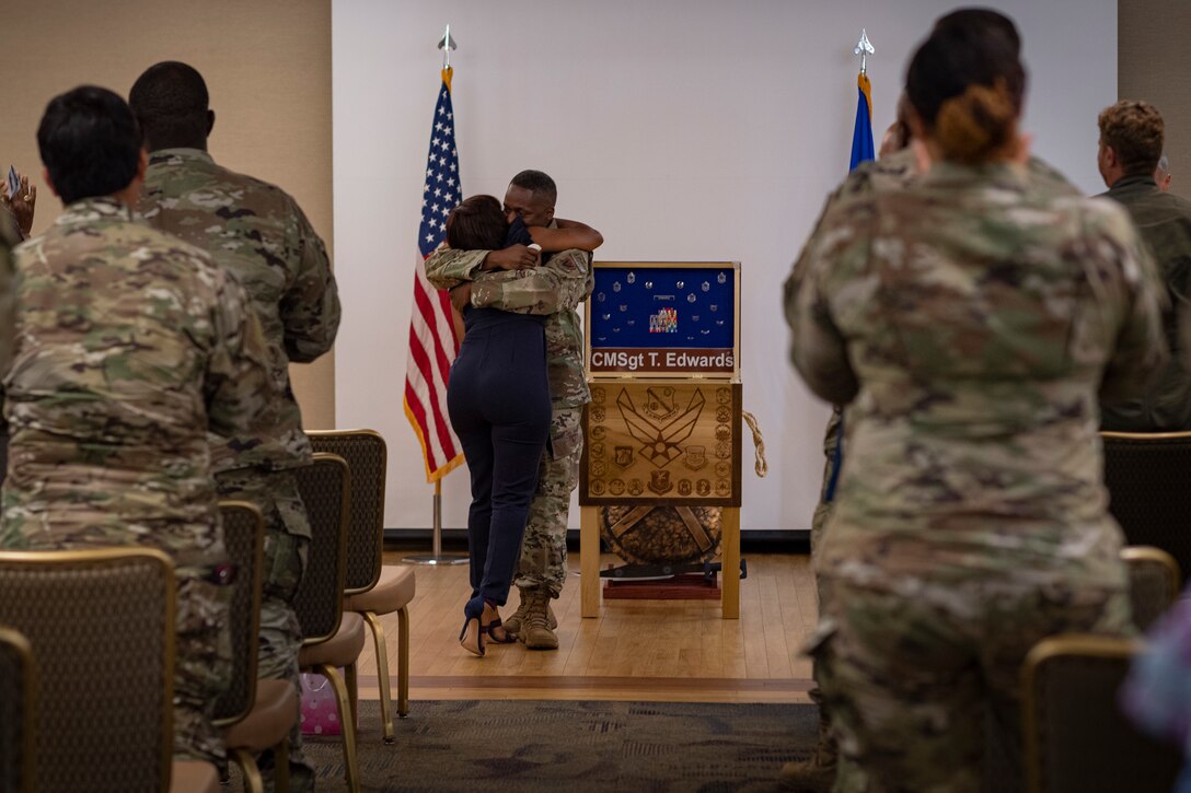 Photo of an Airman hugging his wife