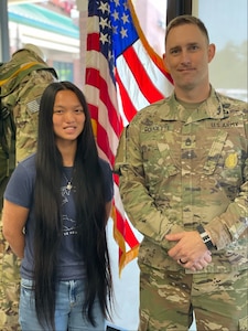 photo of a young lady and a man in uniform.