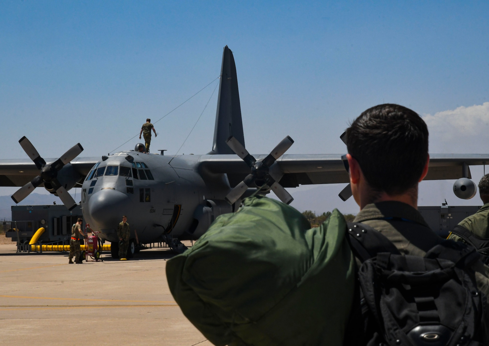 A photo of a pilot walking towards an aircraft