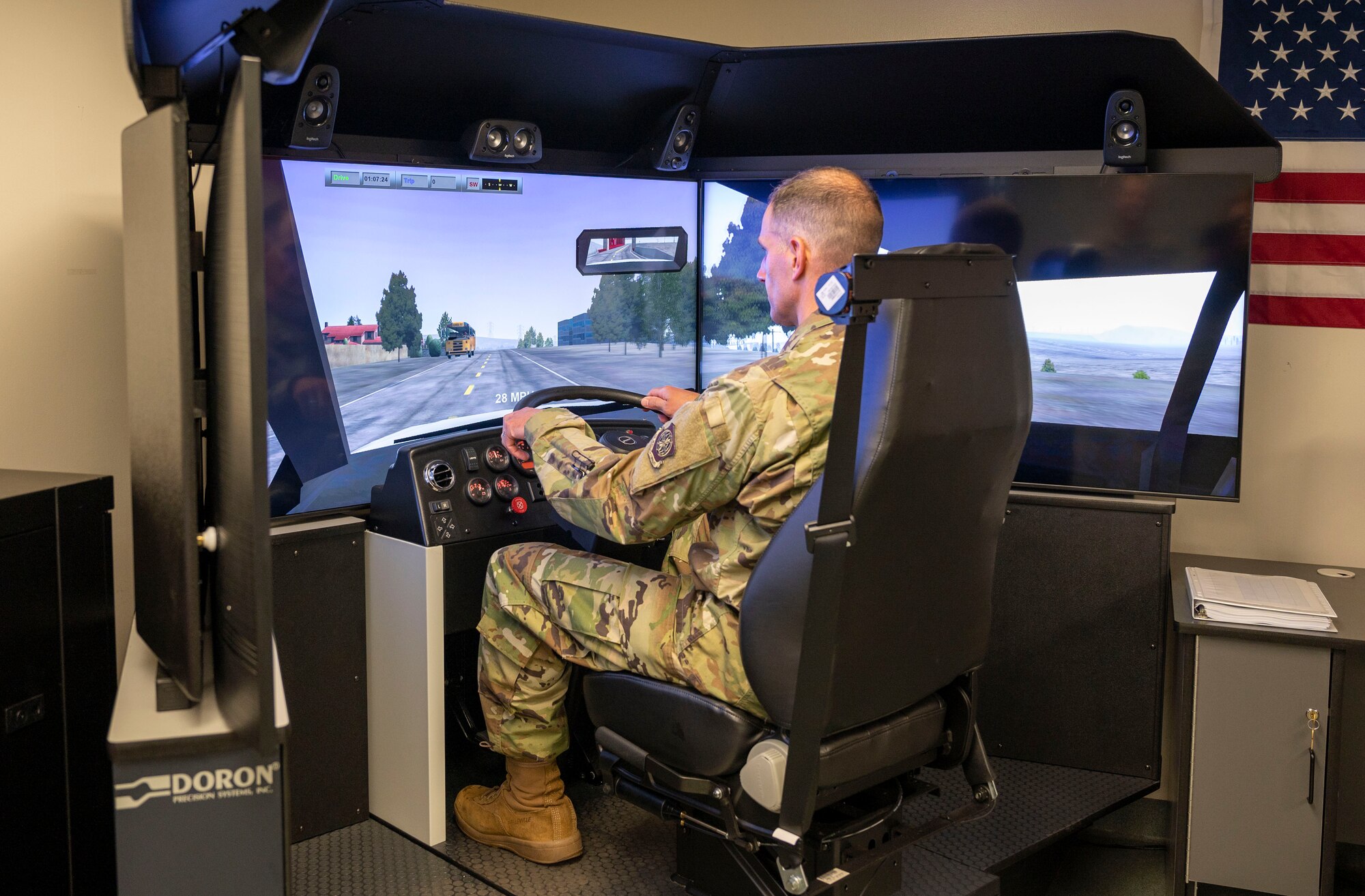 Col. Matt Husemann, 436th Airlift Wing commander, operates a 550Truckplus driving simulator at Dover Air Force Base, Delaware, June 22, 2021. The simulator immerses drivers in various weather conditions, vehicles, road conditions and equipment malfunctions to produce a safe, well-rounded training environment. (U.S. Air Force photo by Airman 1st Class Cydney Lee)