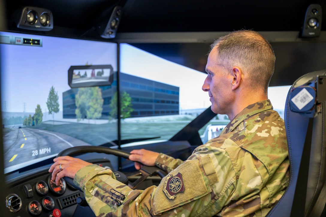 Col. Matt Husemann, 436th Airlift Wing commander, operates a 550Truckplus driving simulator at Dover Air Force Base, Delaware, June 22, 2021. The simulator immerses drivers in various weather conditions, vehicles, road conditions and equipment malfunctions to produce a safe, well-rounded training environment. (U.S. Air Force photo by Airman 1st Class Cydney Lee)
