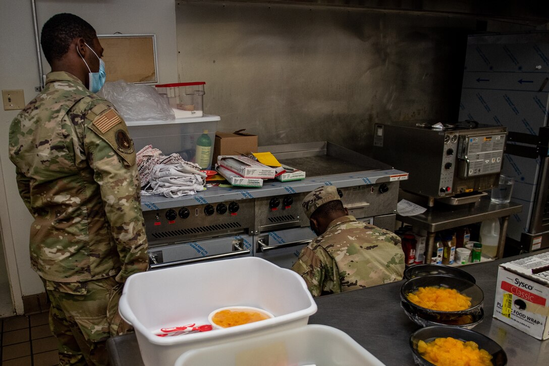 Airman Rahjier Scott, left, 4th Civil Engineer Squadron electrician systems apprentice and Staff Sgt. Sterlin Perkins, 4th CES electrician systems craftsman, inspect equipment at the Southern Eagle Dining Facility, Seymour Johnson Air Force Base, North Carolina, June 23, 2021. Electricians are responsible for both outdoor and indoor electrical equipment on base, from power lines to wall outlets. (U.S. Air Force photo by Airman 1st Class David Lynn)