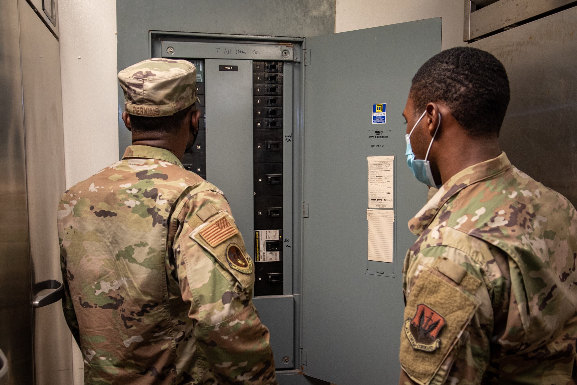 Airman Rahjier Scott, right, 4th Civil Engineer Squadron electrical systems apprentice, and Staff Sgt. Sterlin Perkins, 4th CES electrician systems craftsman, check a circuit breaker at Seymour Johnson Air Force Base, North Carolina, June 23, 2021. Regular inspections of the electrical system ensure the appliance is not using more than the designated amount of electricity. (U.S. Air Force photo by Airman 1st Class David Lynn)