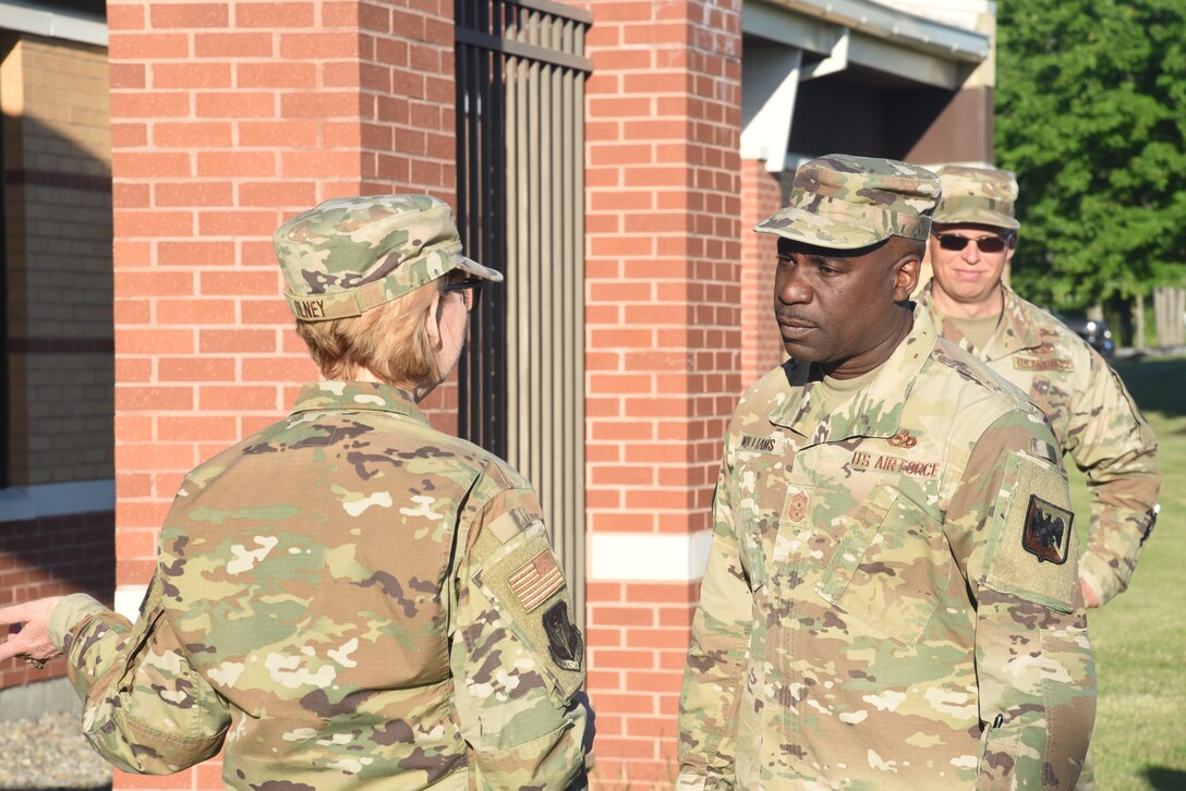 U.S. Air Force Chief Master Sgt. Maurice L. Williams, center, command chief, Air National Guard, speaks with Master Sgt. Barbara Olney, superintendent, 174th Attack Wing Public Affairs, New York National Guard, during a visit to Hancock Field Air National Guard Base, Syracuse, New York, June 24, 2021. Williams' visit is part of an ongoing effort he has to engage and learn from Airmen in ANG units across the country. (U.S. Air National Guard photo by Airman 1st Class Tiffany Scofield)