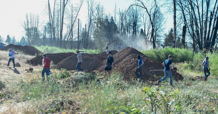 A team of Airmen volunteers from Beale Air Force Base work with a variety of tools to clear fire fuel, June 25, 2021, in Paradise, California.