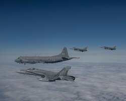 Royal Canadian Air Force CF-18 fighters from the 433 Tactical Fighter Squadron, 3 Wing, Bagotville, U.S. Air Force F-16 fighters from the 140th Wing, Colorado Air National Guard, and an Royal Canadian Air Force CP-140 Long Range Patrol aircraft from 14 Wing, Greenwood, Nova Scotia, conduct a mission over the Northeast corner of Newfoundland and Labrador during the Exercise Amalgam Dart on the Monday June 14, 2021.