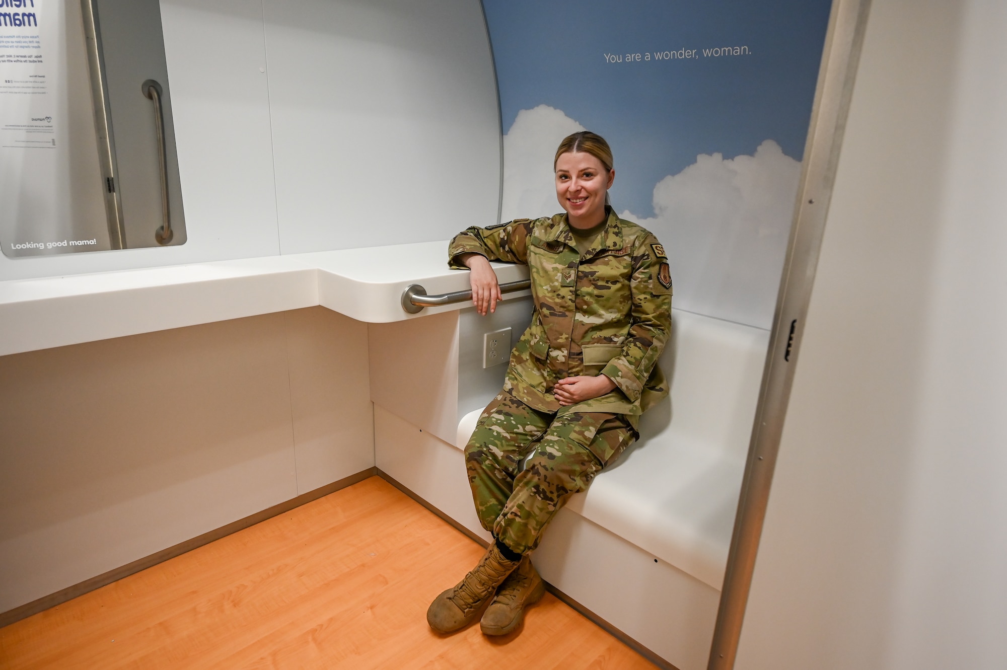 Senior Airman Brice Larimer, 75th Security Forces Squadron, an expectant mother, poses inside the new lactation pod June 28, 2021, located at building 430 at Hill Air Force Base, Utah. The pod features two comfortable benches, wall outlets and a locked door to ensure privacy and will be open during building 430 working hours. (U.S. Air Force photo by Cynthia Griggs)