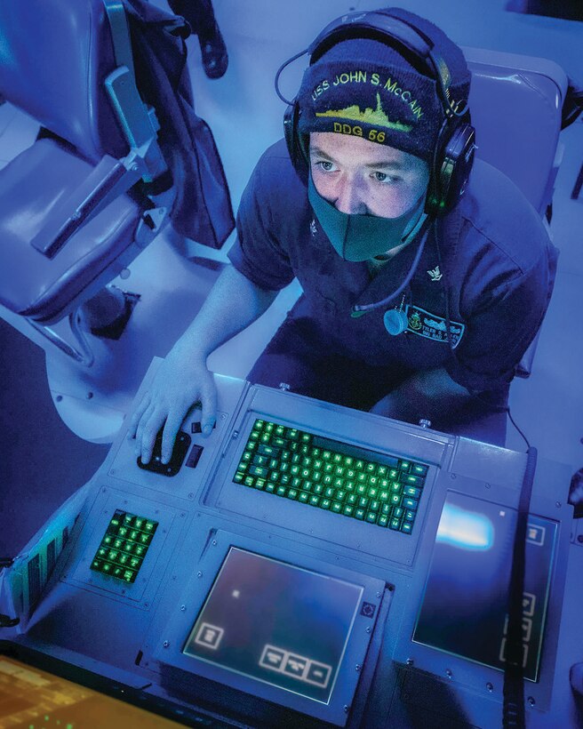Sailor monitors subsurface contacts while standing watch in sonar control room aboard Arleigh Burke–class guided-missile destroyer USS John S. McCain during target-tracking training evolution as part of Malabar 2020, Indian Ocean, November 3, 2020 (U.S. Navy/Markus Castaneda)