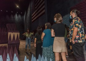 Amarachi Egbuziem-Ciolkosz, an engineer with the 772nd Test Squadron, 412th Electronic Warfare Group, provides a tour of the Benefield Anechoic Facility during the 412th EWG Family Day at Edwards Air Force Base, California, June 18. (Air Force photo by Bryce Bennett)