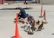 Col. Jay Orson, 412th Electronic Warfare Group commander, wipes out as Col. Randel Gordon, 412th Test Wing vice commander, goes for the win during a tricycle obstacle course race at the 412th EWG Family Day at Edwards Air Force Base, June 18. (Air Force photo by Bryce Bennett)
