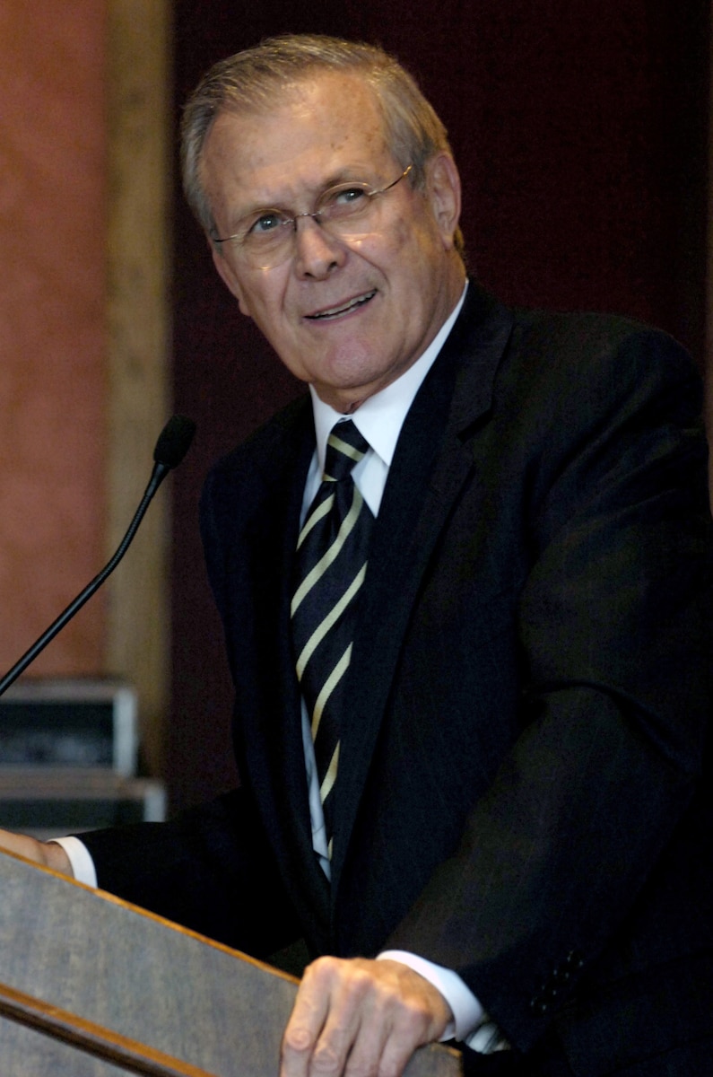 Defense Secretary Donald H. Rumsfeld stands at a lectern.
