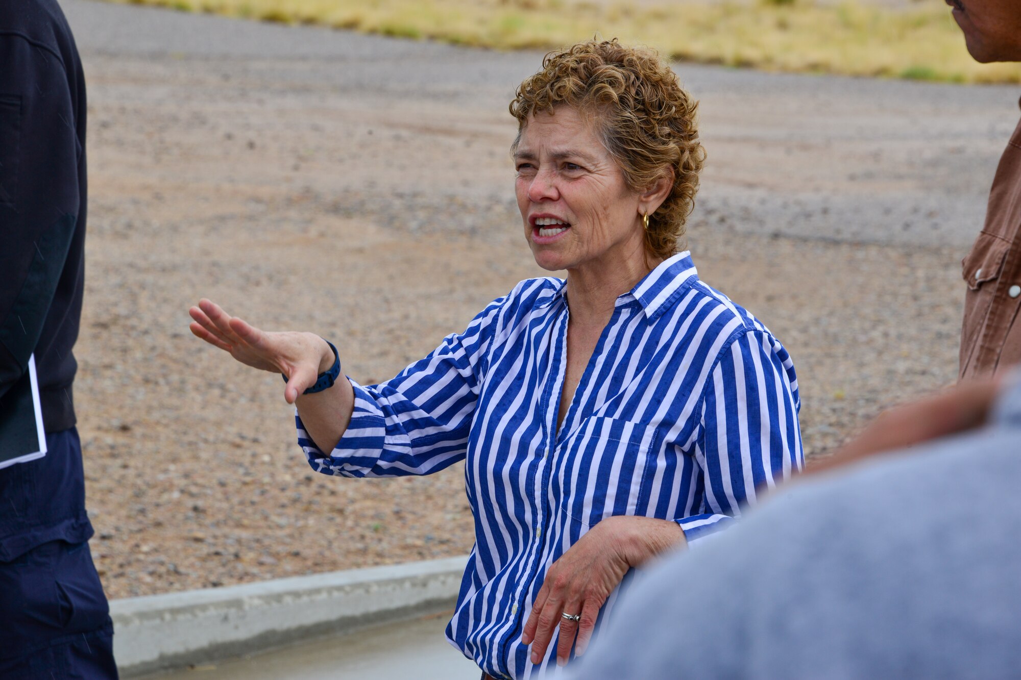 Lady explaining spill prevention to a small group of people at Kirtland, AFB.