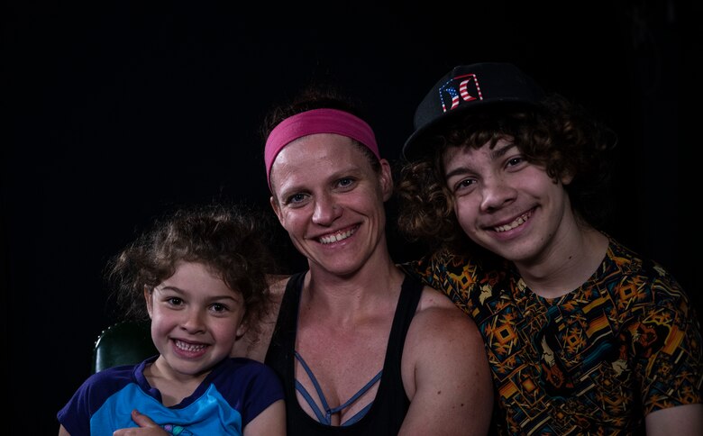 A small family smiles for the camera.