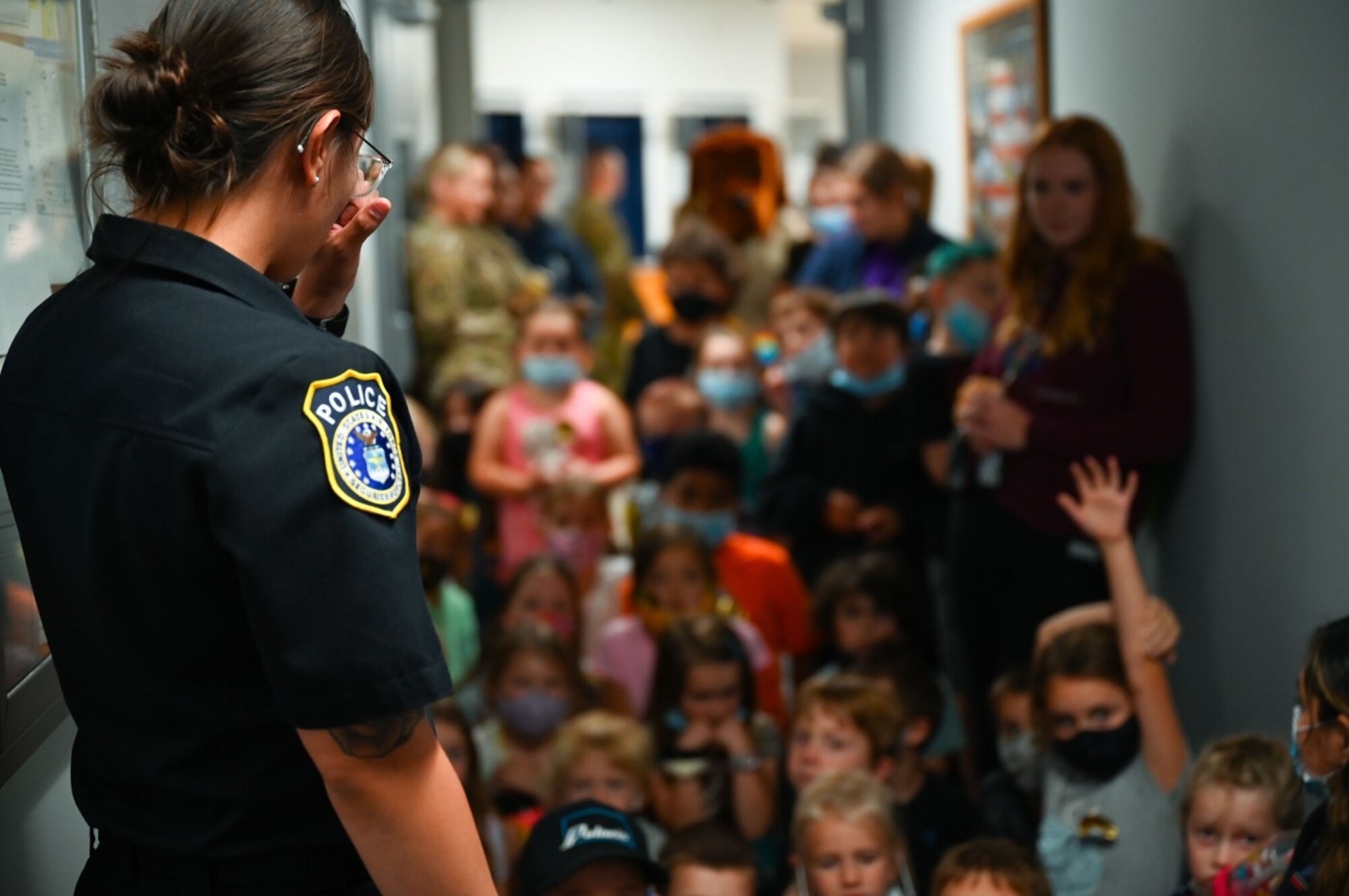 Nikki McManigal, a security forces leader assigned to the 28th Security Forces Squadron, answers questions from children of the Ellsworth School Age Care program during a visit on Ellsworth Air Force Base, S.D., June 25, 2021