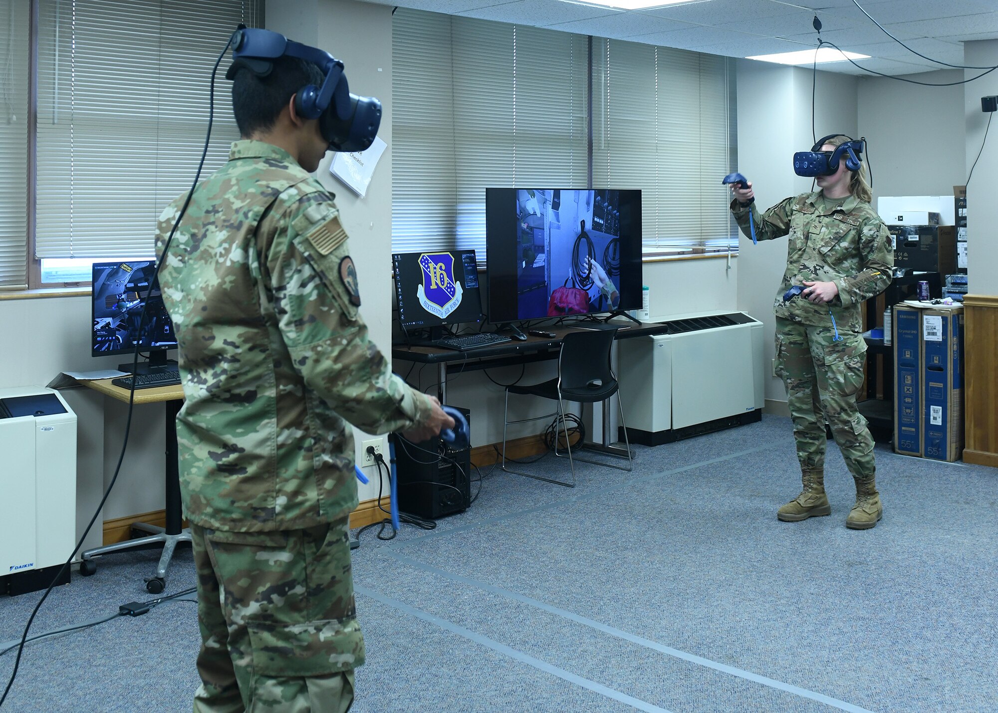 Man and woman in uniform wear virtual reality headsets while training