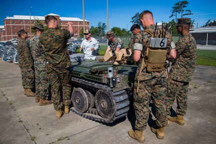 U.S. Marines with 1st Battalion, 2d Marine Regiment (1/2), 2d Marine Division, receive training from Matthew Foglesong, the Robotics and Autonomy branch head with the Marine Corps Warfighting Lab, on the employment of an Expeditionary Modular Autonomous Vehicle (EMAV) on Camp Lejeune, N.C., June 24, 2021. The purpose of this training is to provide electronic warfare services to a supported unit commander. The EMAV is a highly mobile and fully autonomous ground vehicle that has a payload capacity of 7,200 pounds. (U.S. Marine Corps photo by Lance Cpl. Emma L. Gray)