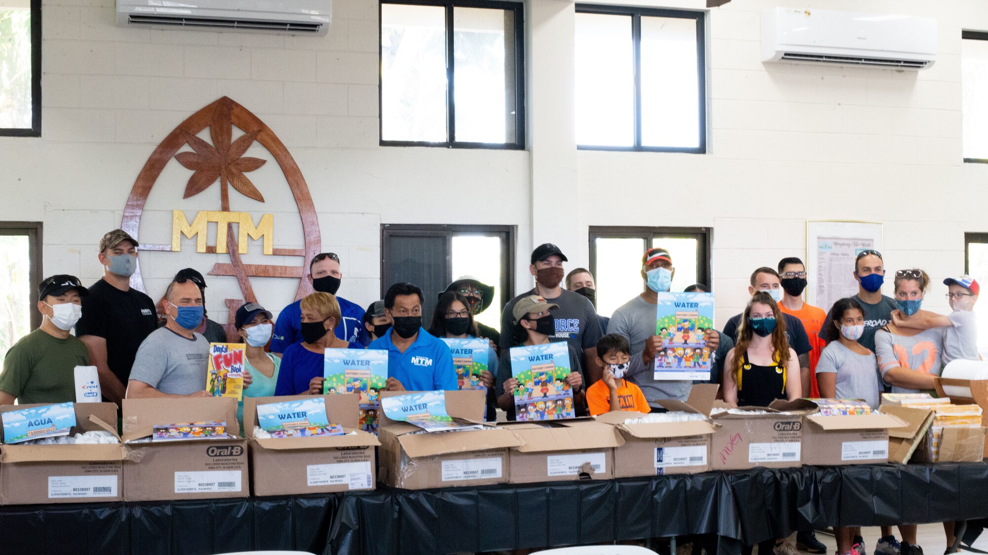 36th Operational Medical Readiness Squadron volunteers and the Mongmong-Toto-Maite mayor's office pose with 500 boxes of dental hygein products at Mongmong-Toto-Maite, Guam, Feb. 27, 2021.