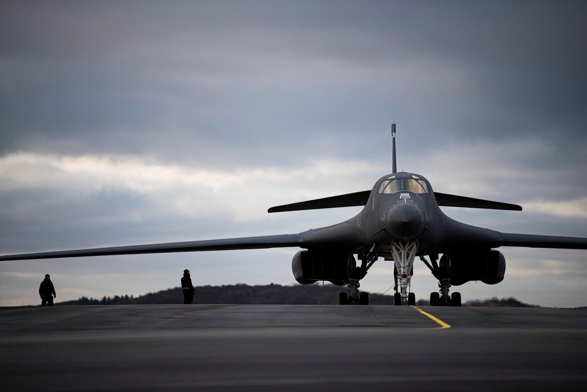 Two crew chiefs assigned to the 9th Aircraft Maintenance Unit stand by a B-1B Lancer on the flightline at Ørland Air Force Station, Norway, Feb. 26, 2021. B-1 crew chiefs provide aircraft maintenance necessary to ensure Bomber Task Force mission success. (U.S. Air Force photo by Airman 1st Class Colin Hollowell)