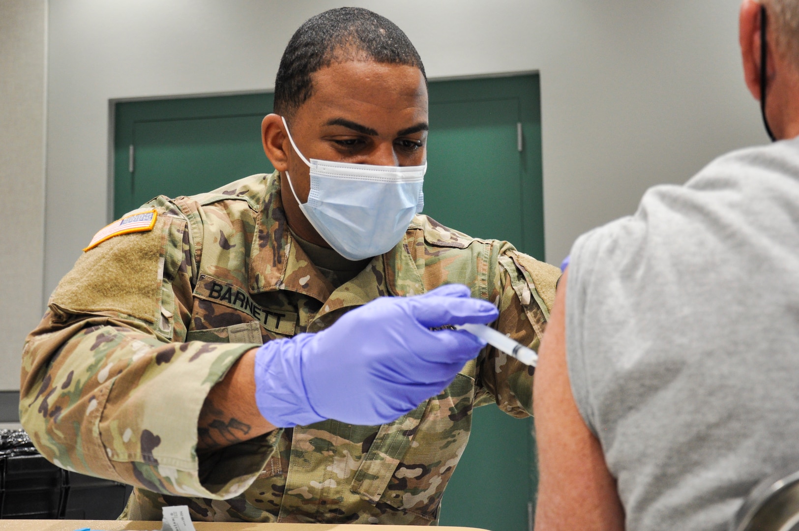 Nevada National Guard Spc. Demetrie Barnett with Joint Task Force 17 administers the Pfizer vaccine to residents at the Cora Coleman Senior Center, Feb. 16, 2021, in Las Vegas.