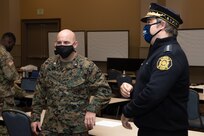 U.S. Marine Corps Lt. Col. James Thornburg Jr, left, commanding officer of Combat Logistics Battalion 22 (CLB-22), and Adam K. Thiel, right, director of the Philadelphia Office of Emergency Management, discuss safety preparation during the setup of the state-run, federally-supported COVID-19 Community Vaccination Center at the Pennsylvania Convention Center in Philadelphia, Feb. 28, 2021.