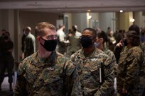 U.S. Marines and U.S. Navy Sailors assigned to Combat Logistics Battalion 22 (CLB-22)  wait for a tour of the vaccination site during the setup of the state-run, federally-supported COVID-19 Community Vaccination Center at the Pennsylvania Convention Center in Philadelphia, Feb. 28, 2021.