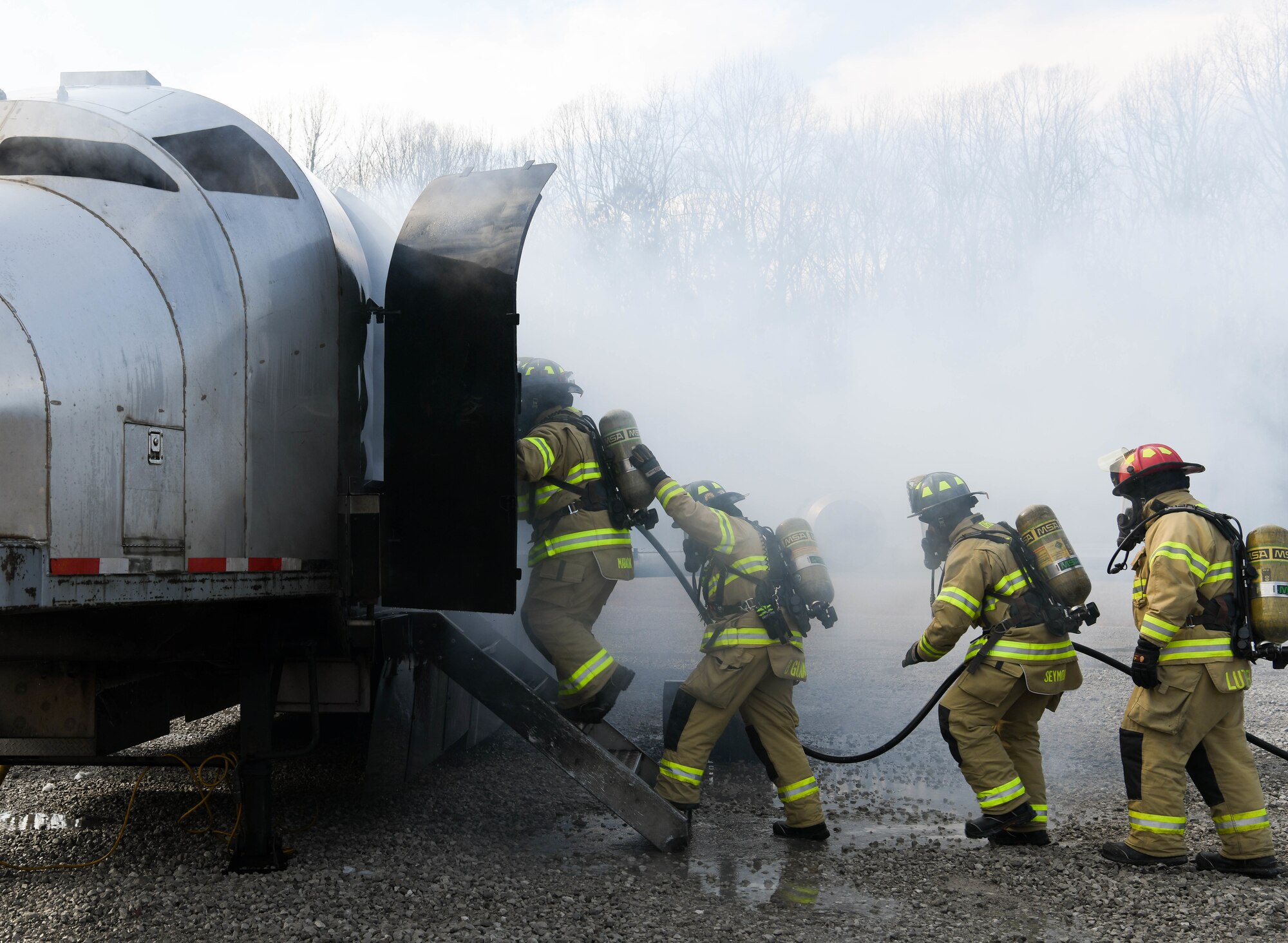 Arnold Air Force Base Fire and Emergency Services personnel enter a mock aircraft while training, Feb. 8, 2021, using a propane-fueled trainer brought to the base. Firefighters battled exterior fires before making entry where they faced additional fires and had to search for simulated victims. (U.S. Air Force photo by Jill Pickett)