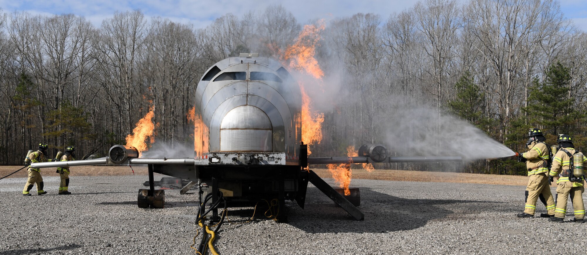 Arnold Air Force Base Fire and Emergency Services crews train Feb. 10, 2021, on aircraft rescue and firefighting techniques using a propane-fueled trainer brought to the base. (U.S. Air Force photo by Jill Pickett)