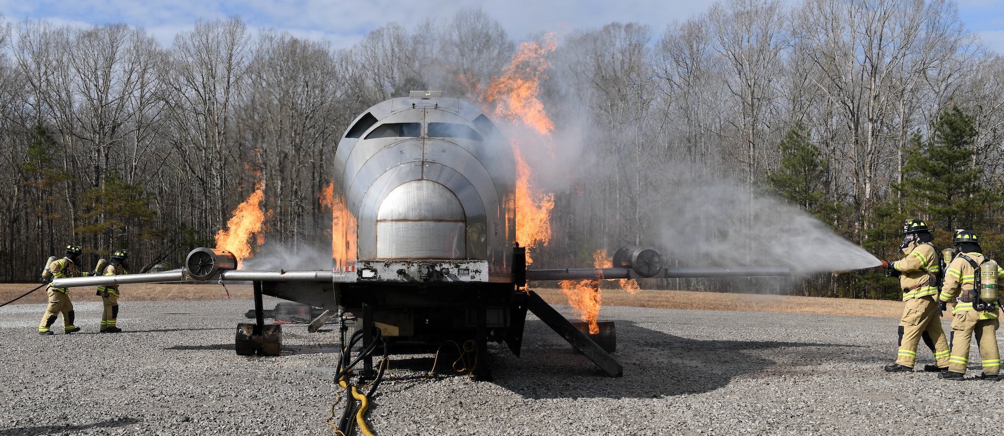 Arnold Air Force Base Fire and Emergency Services crews train Feb. 10, 2021, on aircraft rescue and firefighting techniques using a propane-fueled trainer brought to the base. (U.S. Air Force photo by Jill Pickett)