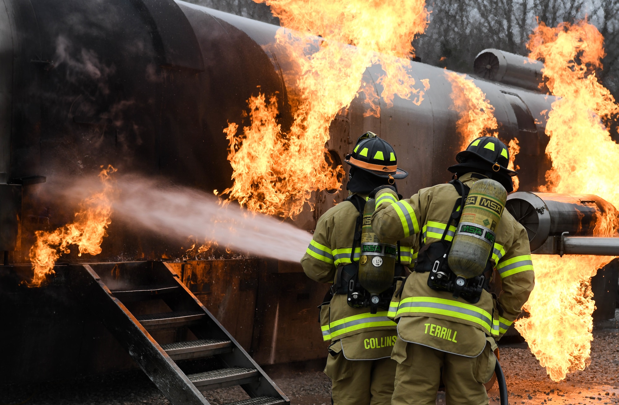 Arnold Air Force Base Fire and Emergency Services personnel battle a fuselage fire as they train, Feb. 9, 2021, on aircraft rescue and firefighting techniques at Arnold AFB, Tenn. The firefighters attacked the fire first with vehicle-mounted nozzles, then hand lines on the external blazes, before making entry into the aircraft. (U.S. Air Force photo by Jill Pickett)