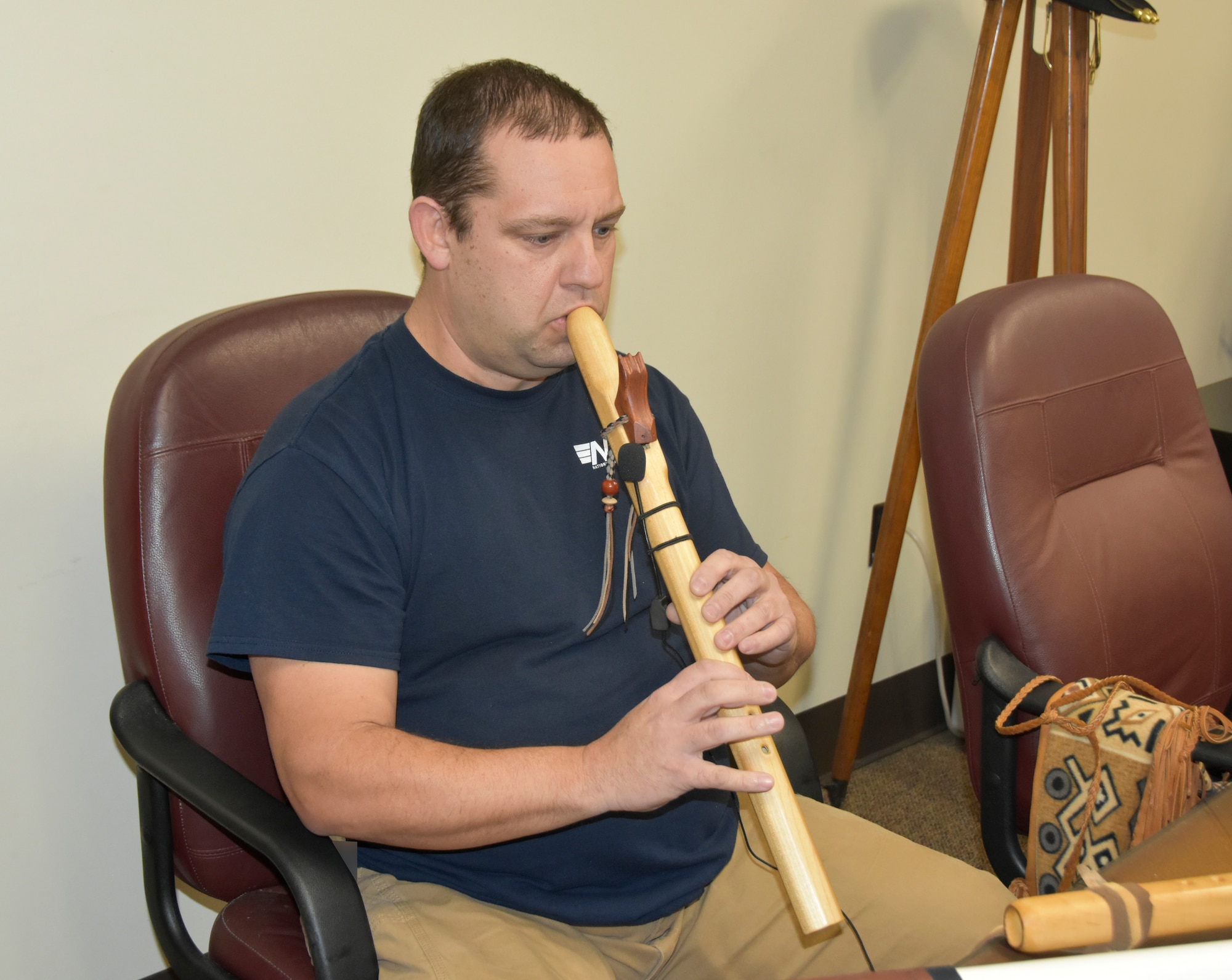 Kevin Ashley, an inside machinist with the Arnold Engineering Development Complex Model and Machine Shop at Arnold Air Force Base, Tenn., plays one of the Native American flutes he made. Ashley began playing the Native American flute around 20 years ago after purchasing his first and has been making his own flutes for more than a decade. (U.S. Air Force photo by Bradley Hicks) (This image has been altered by obscuring badges for security purposes.)